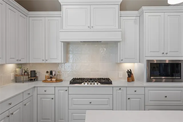 a bathroom with a sink double vanity granite tub shower and a mirror