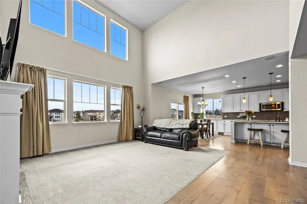 a living room with furniture and large windows