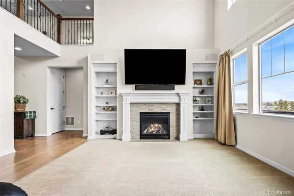 a living room with furniture a flat screen tv and a fireplace
