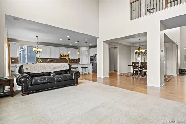 a large bedroom with a bed and wooden floor