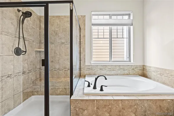 a bathroom with a bathtub and shower