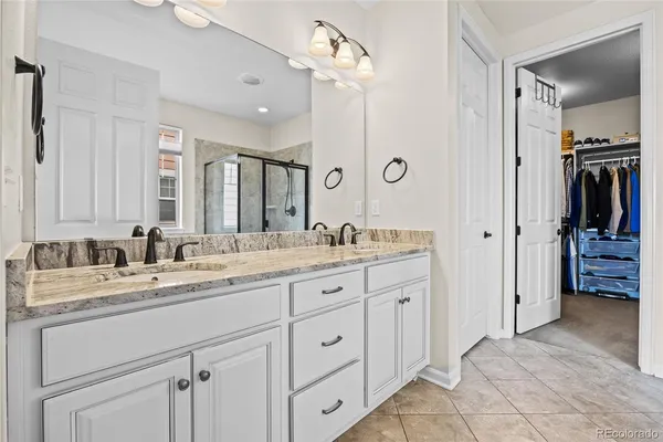 a bathroom with a granite countertop sink double vanity
