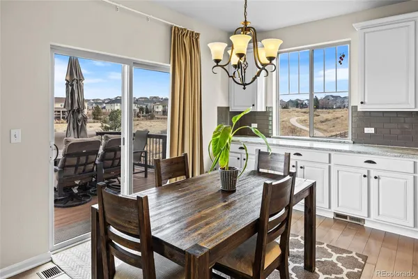 a view of a dining room with furniture window and wooden floor