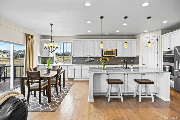 a kitchen with kitchen island granite countertop wooden cabinets and stainless steel appliances