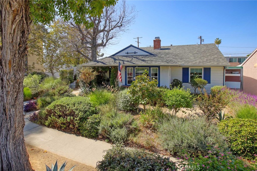 a view of a house with a small yard and plants