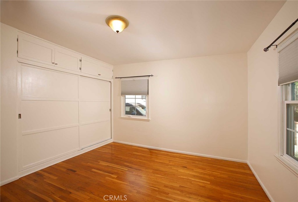 6903 Halbrent Avenue Van Nuys, CA 91405 - Photo 4 of 10 a view of empty room with wooden floor and fan