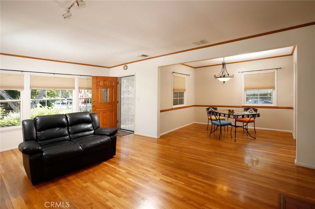 6903 Halbrent Avenue Van Nuys, CA 91405 - Photo 5 of 10 a living room with furniture and a wooden floor