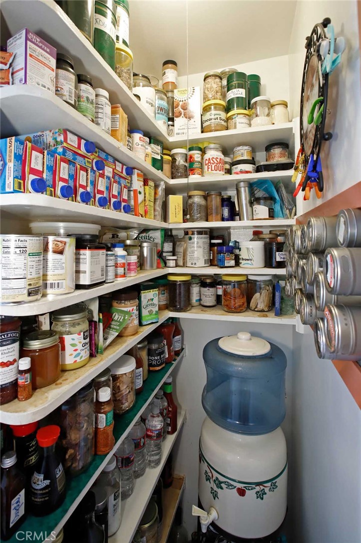 6903 Halbrent Avenue Van Nuys, CA 91405 - Photo 7 of 10 a room with stainless steel appliances a rug and a book shelf