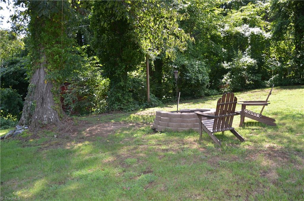 1072 Cantering Road High Point, NC 27262 - Photo 26 of 28 Fire Pit in Partially Wooded Backyard