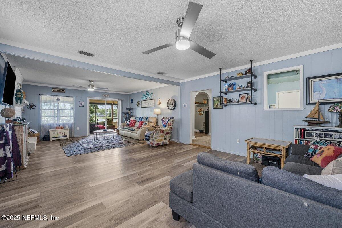 832 Lake Shore Terrace Interlachen, FL 32148 - Photo 11 of 42 a living room with furniture and a flat screen tv