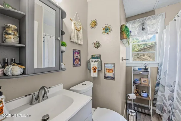 a bathroom with a sink toilet and a mirror