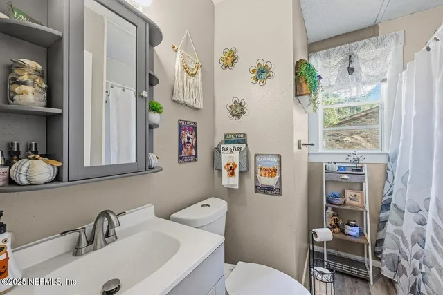 a bathroom with a sink toilet and a mirror