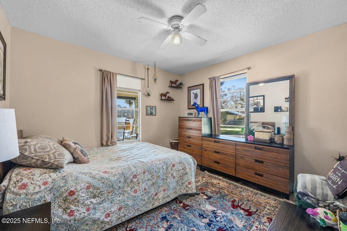 832 Lake Shore Terrace Interlachen, FL 32148 - Photo 17 of 42 a bedroom with a bed and a dresser in it