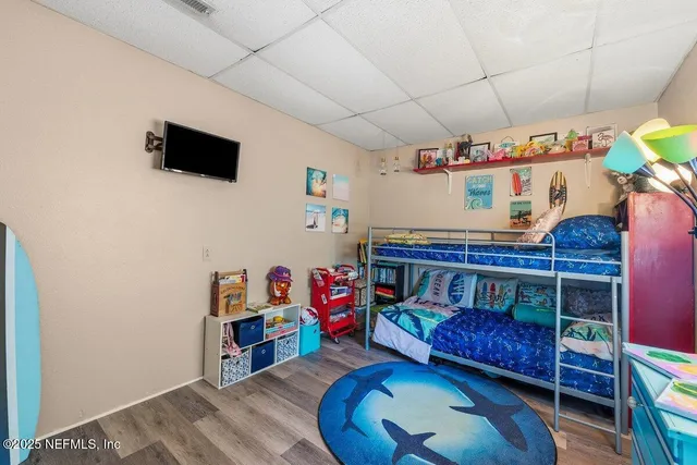 a room with furniture a flat screen tv and a dresser