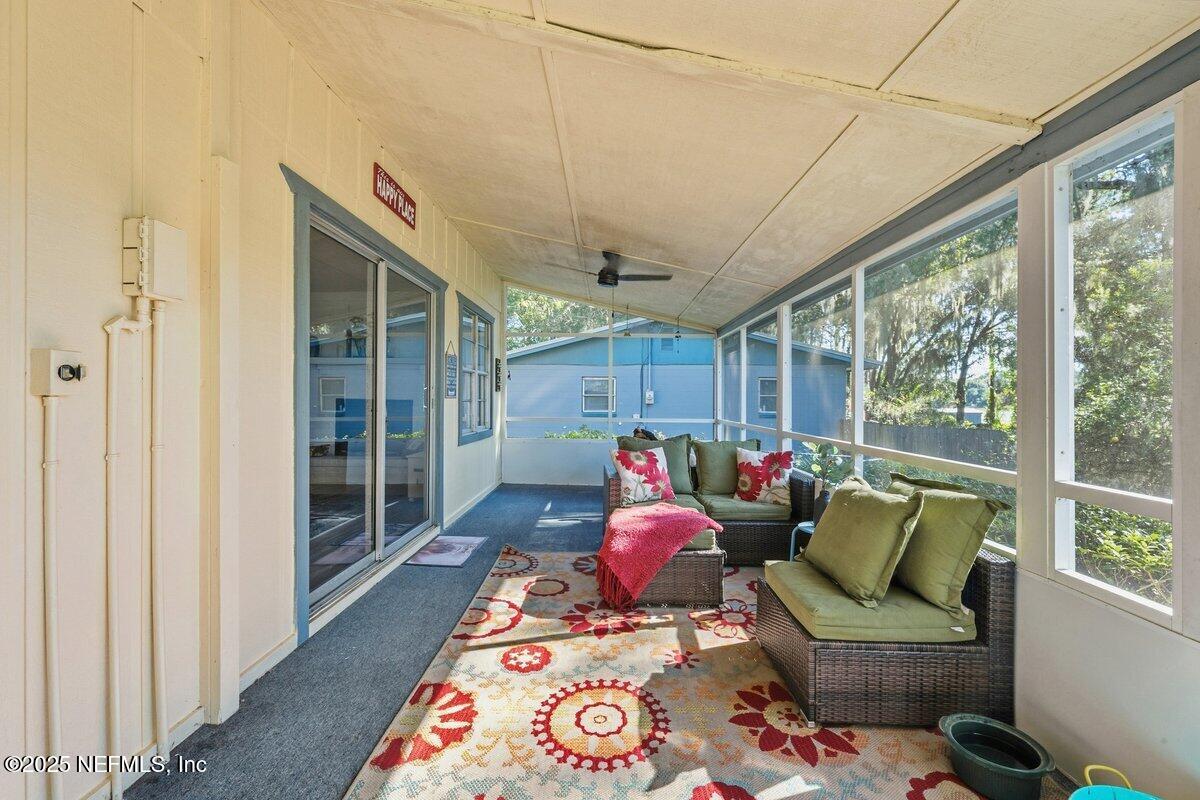 832 Lake Shore Terrace Interlachen, FL 32148 - Photo 21 of 42 a living room with furniture and a large window