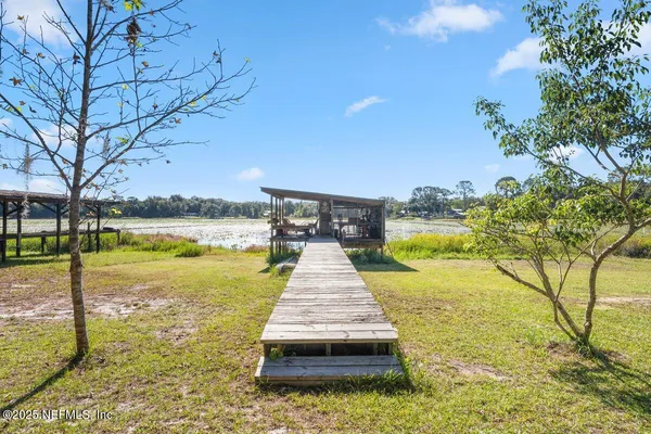 a view of a fountain with swimming pool in front of house