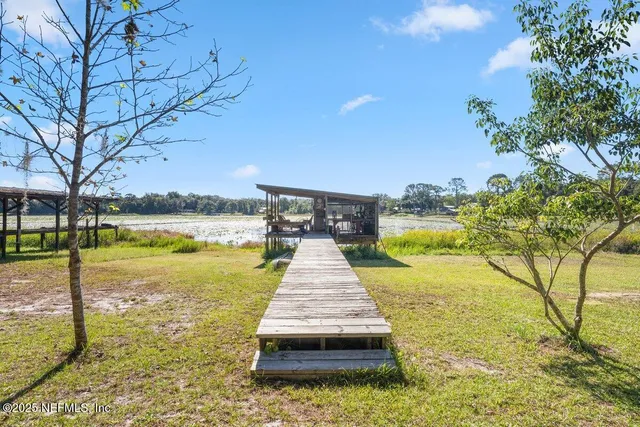 a view of a fountain with swimming pool in front of house