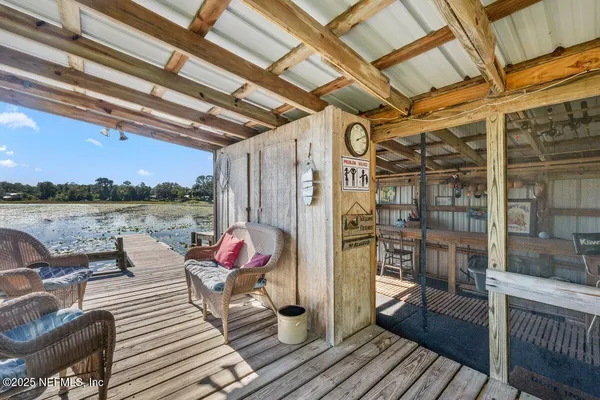 a roof deck with couch and chairs