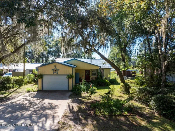 a view of a swimming pool with a bench and trees around