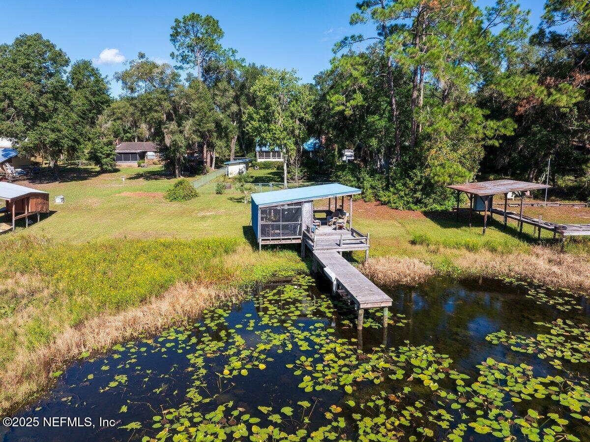 832 Lake Shore Terrace Interlachen, FL 32148 - Photo 33 of 42 a view of a swimming pool with a bench and trees around