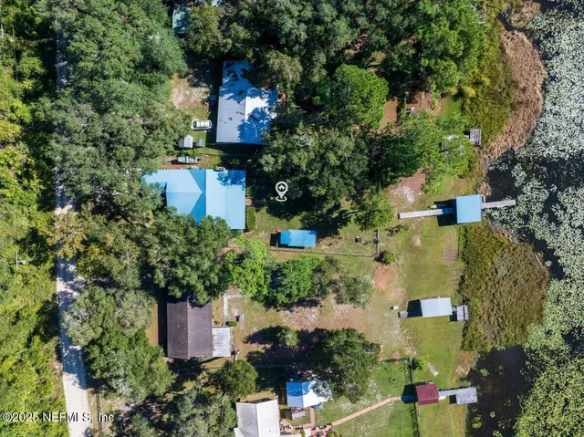 an aerial view of a houses with a yard