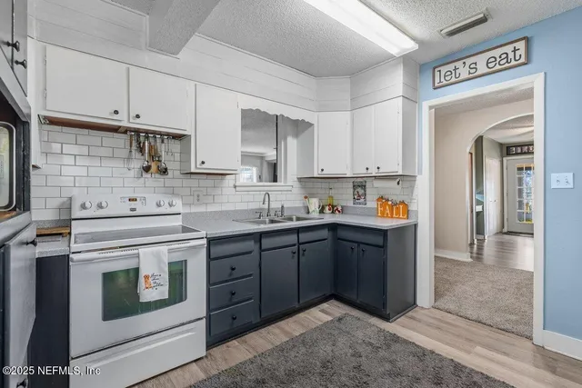 a kitchen with stainless steel appliances granite countertop a stove and a sink