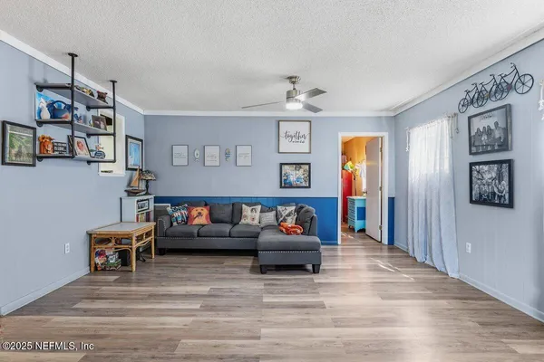 a living room with furniture and a wooden floor