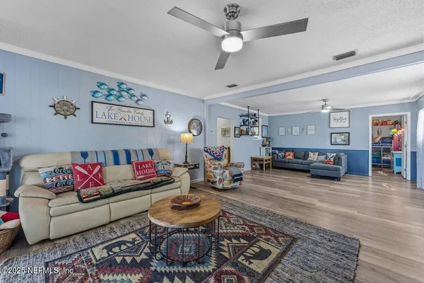 a living room with furniture and a wooden floor