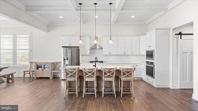 a kitchen with kitchen island a counter top space appliances and cabinets