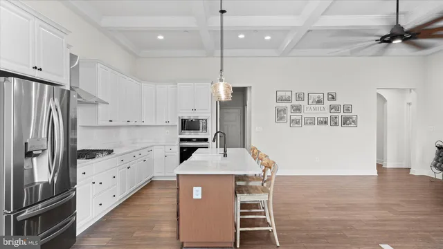 a kitchen with white cabinets a sink and appliances