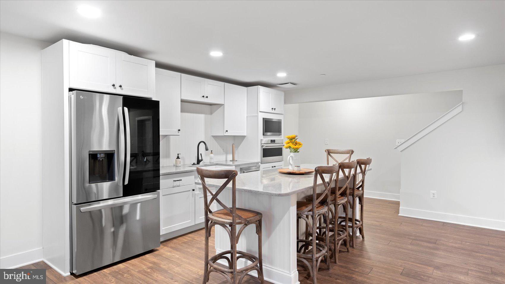 2510 Easy Street Fallston, MD 21047 - Photo 35 of 56 a kitchen with stainless steel appliances a dining table chairs and wooden floor