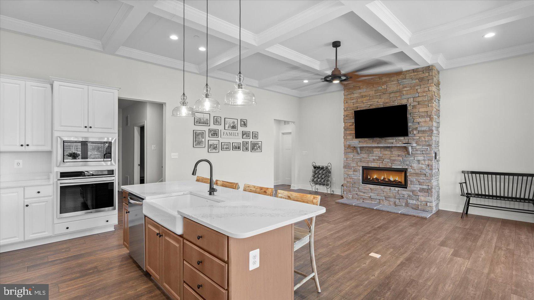 2510 Easy Street Fallston, MD 21047 - Photo 9 of 56 a kitchen with a stove kitchen island a fireplace wooden floor and a counter top space