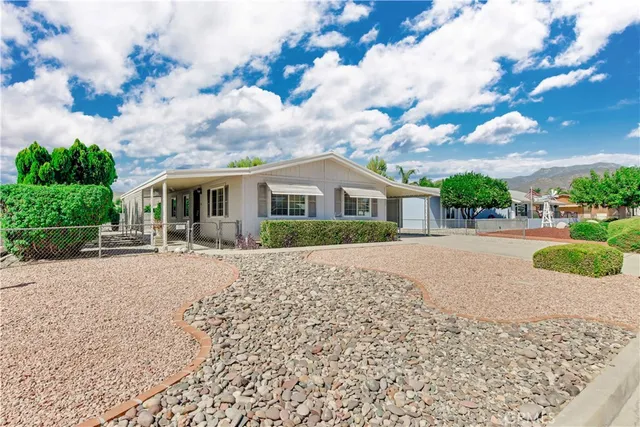 a view of house with outdoor space and garden