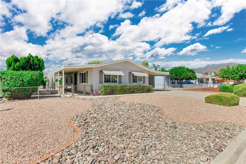 a view of house with outdoor space and garden