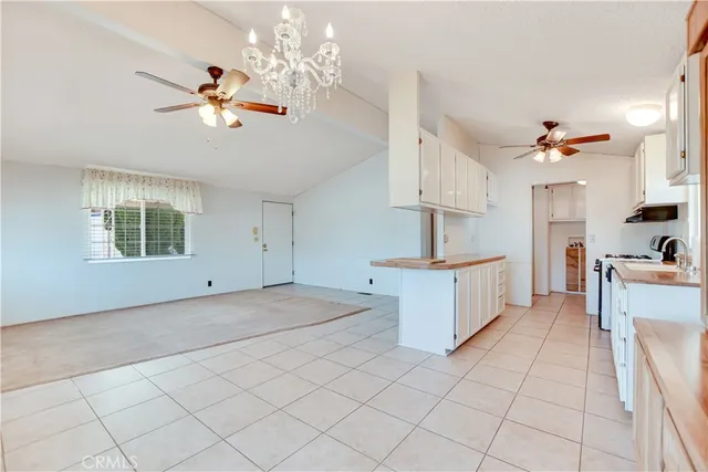 a kitchen with kitchen island granite countertop a sink cabinets and window