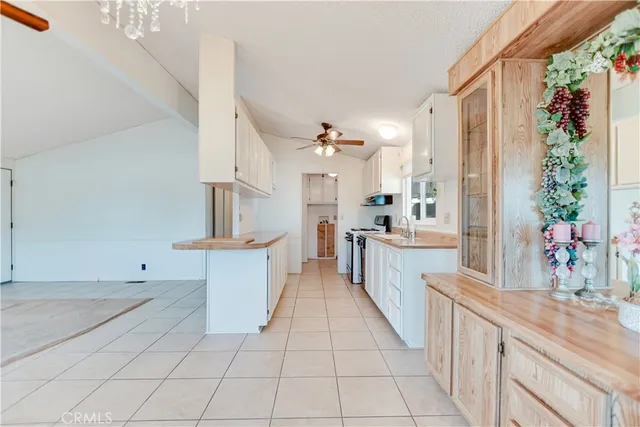 a large white kitchen with a large window