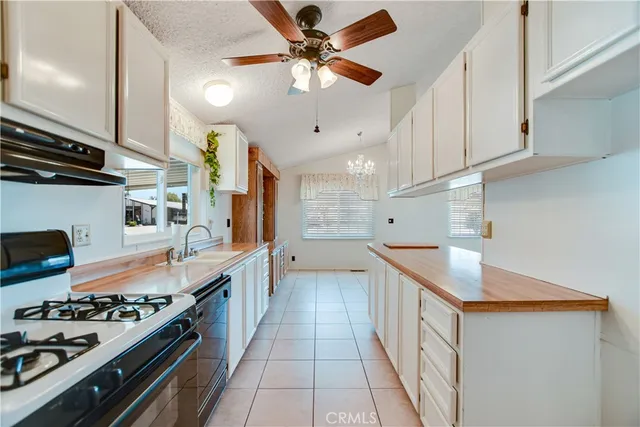 a kitchen with stainless steel appliances a sink stove and cabinets