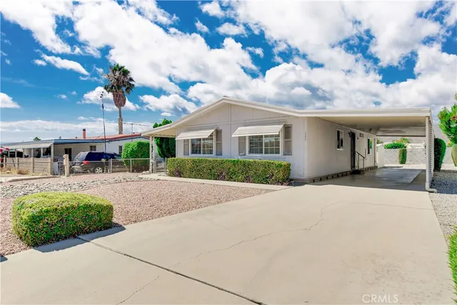a view of a white house with a yard