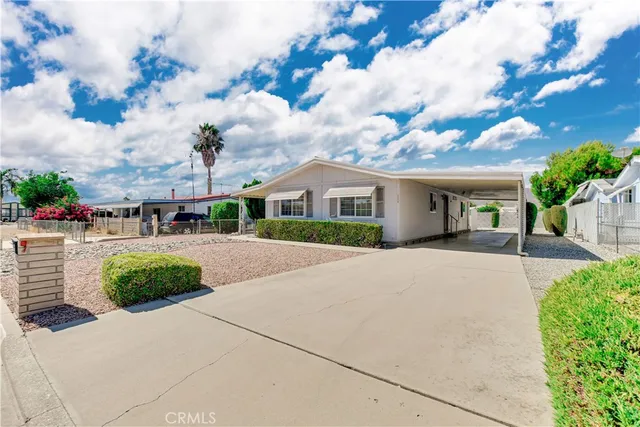 a front view of a house with a yard and outdoor seating
