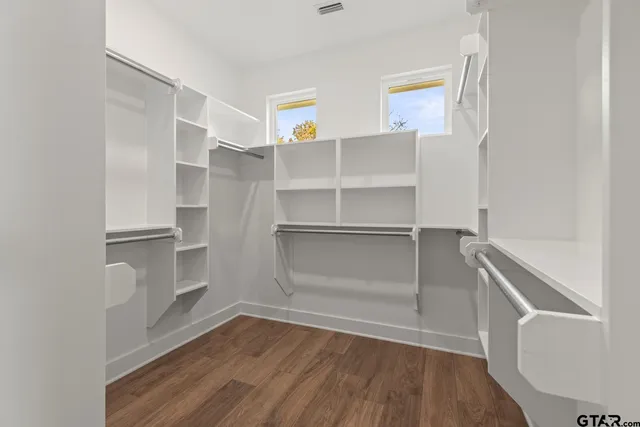 a view of walk in closet with empty racks