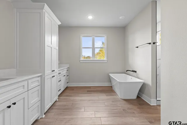 a spacious bathroom with 2 bathtub sink