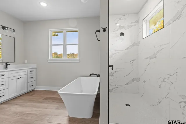 a bathroom with a granite countertop sink a toilet and shower