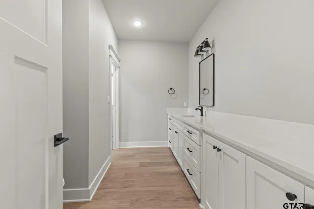 a bathroom with double vanity and mirrors