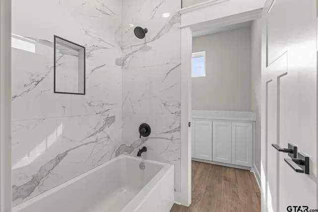 a bathroom with a bathtub and a shower