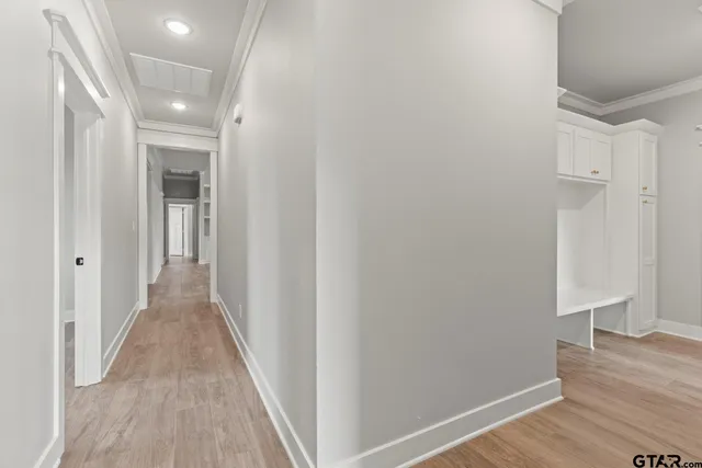 a view of a hallway with wooden floor