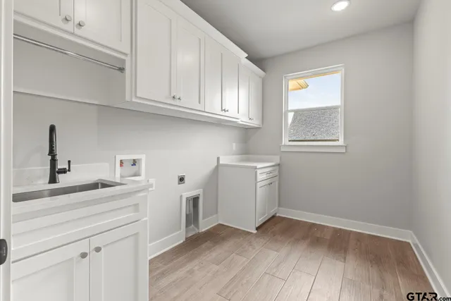 a view of a kitchen with sink and cabinets