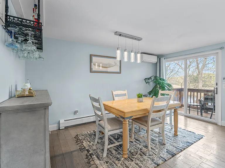 15 Riverview Avenue, Unit D Mashpee, MA 02649 - Photo 8 of 33 a view of a dining room with furniture window and wooden floor