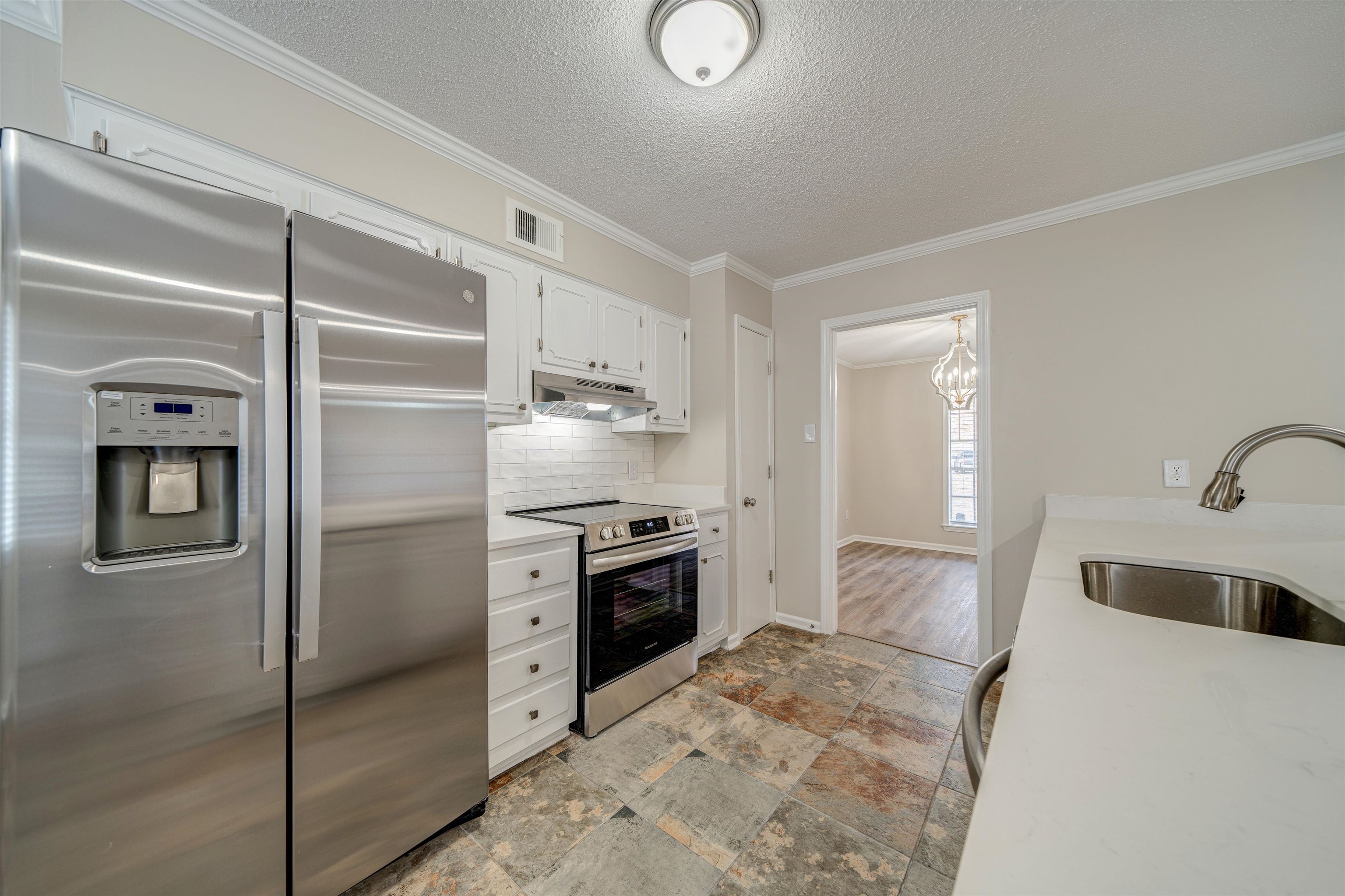 2487 Lynnfield Road Memphis, TN 38119 - Photo 11 of 33 a kitchen with stainless steel appliances granite countertop a refrigerator and a sink