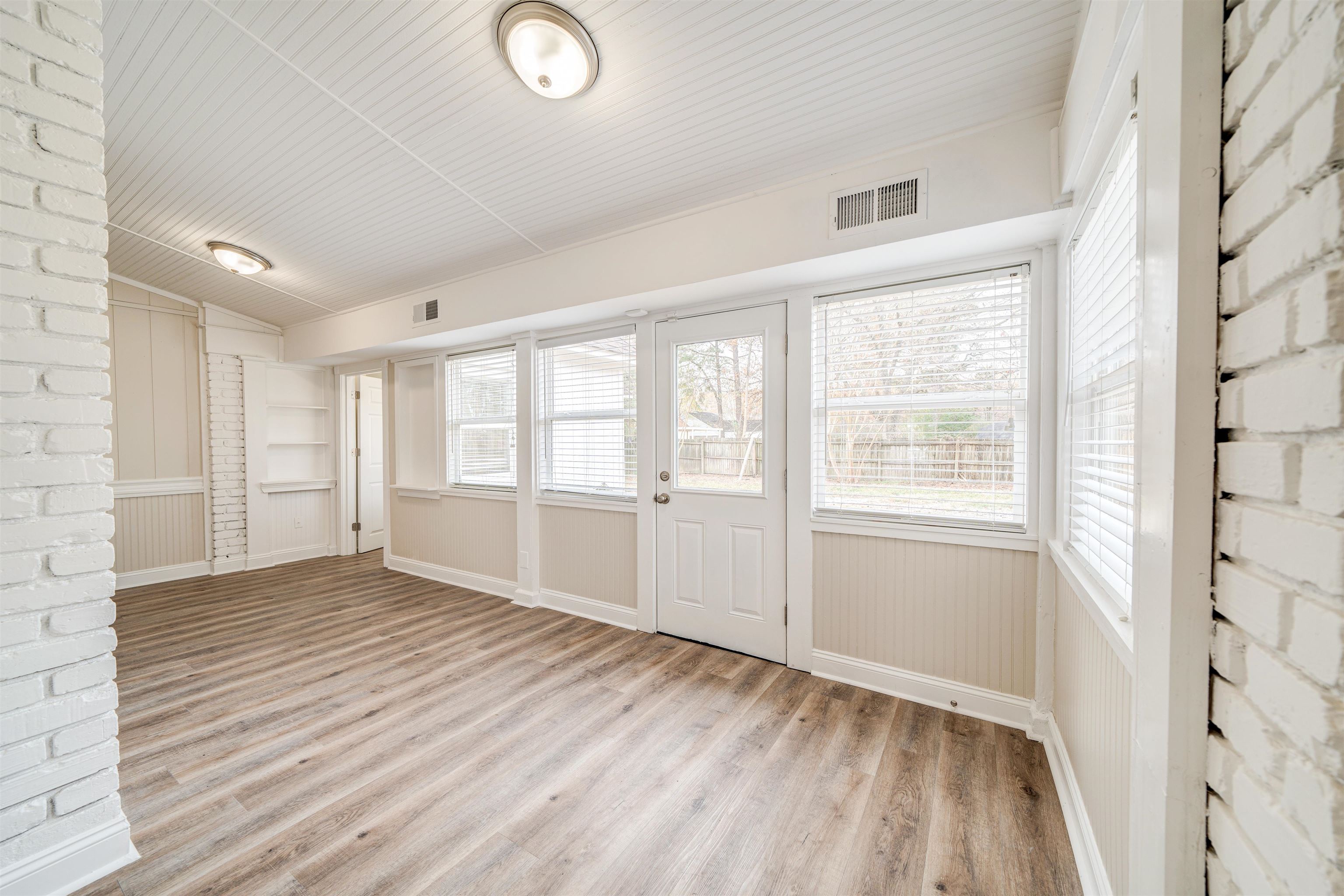 2487 Lynnfield Road Memphis, TN 38119 - Photo 14 of 33 a view of an empty room with a window and wooden floor
