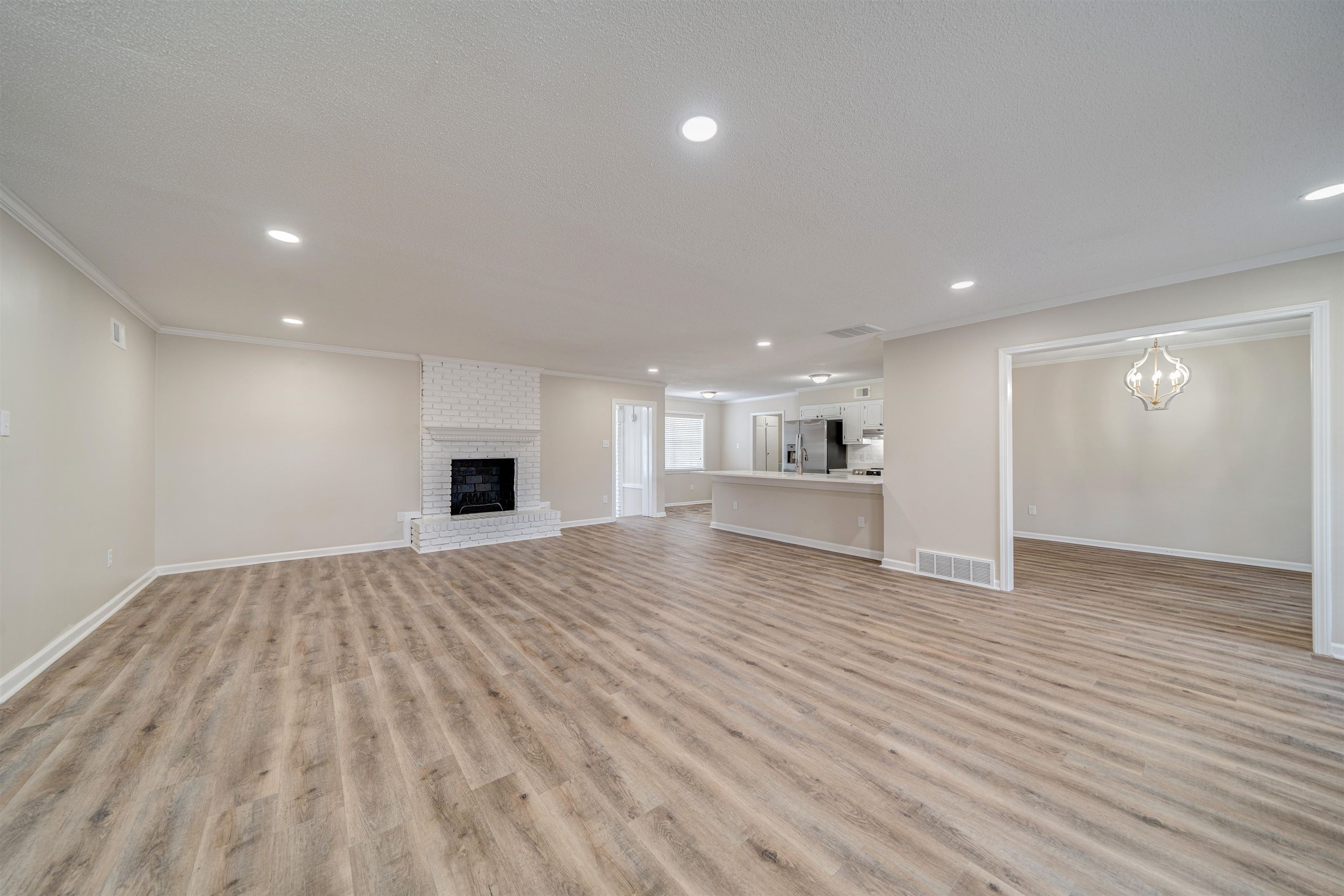 2487 Lynnfield Road Memphis, TN 38119 - Photo 4 of 33 a view of empty room with wooden floor and fireplace